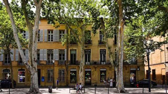 Picturesque view of a tree-lined street in Aix-en-Provence, showcasing classic architecture.
